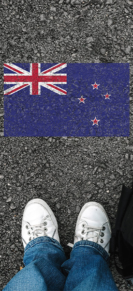 A man with white shoes and flag of New Zealand stock phot