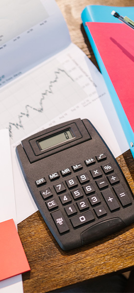 Table with papers and a calculator.