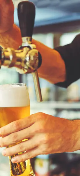 bartender pouring a beer in Holiday Alcohol Licence Restrictions Overhauled