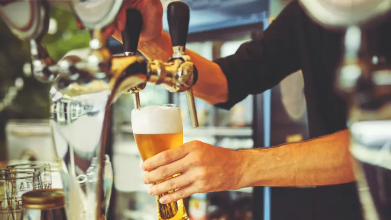 bartender pouring a beer in Holiday Alcohol Licence Restrictions Overhauled