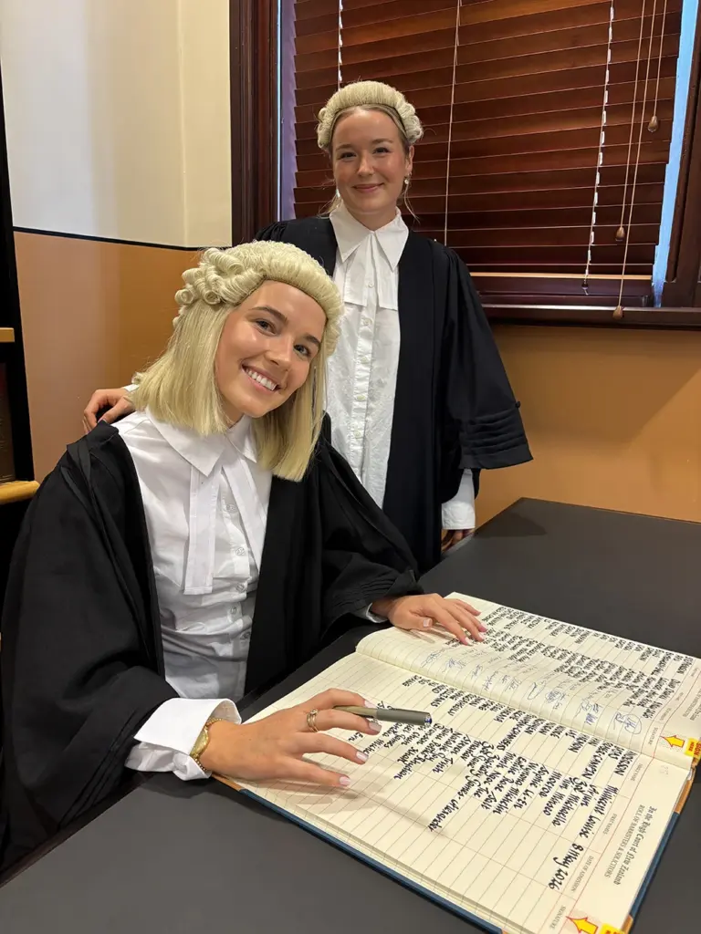 Millie-Fox-from-AWS-Legal-admission-to-the-bar-signing-with-colleague